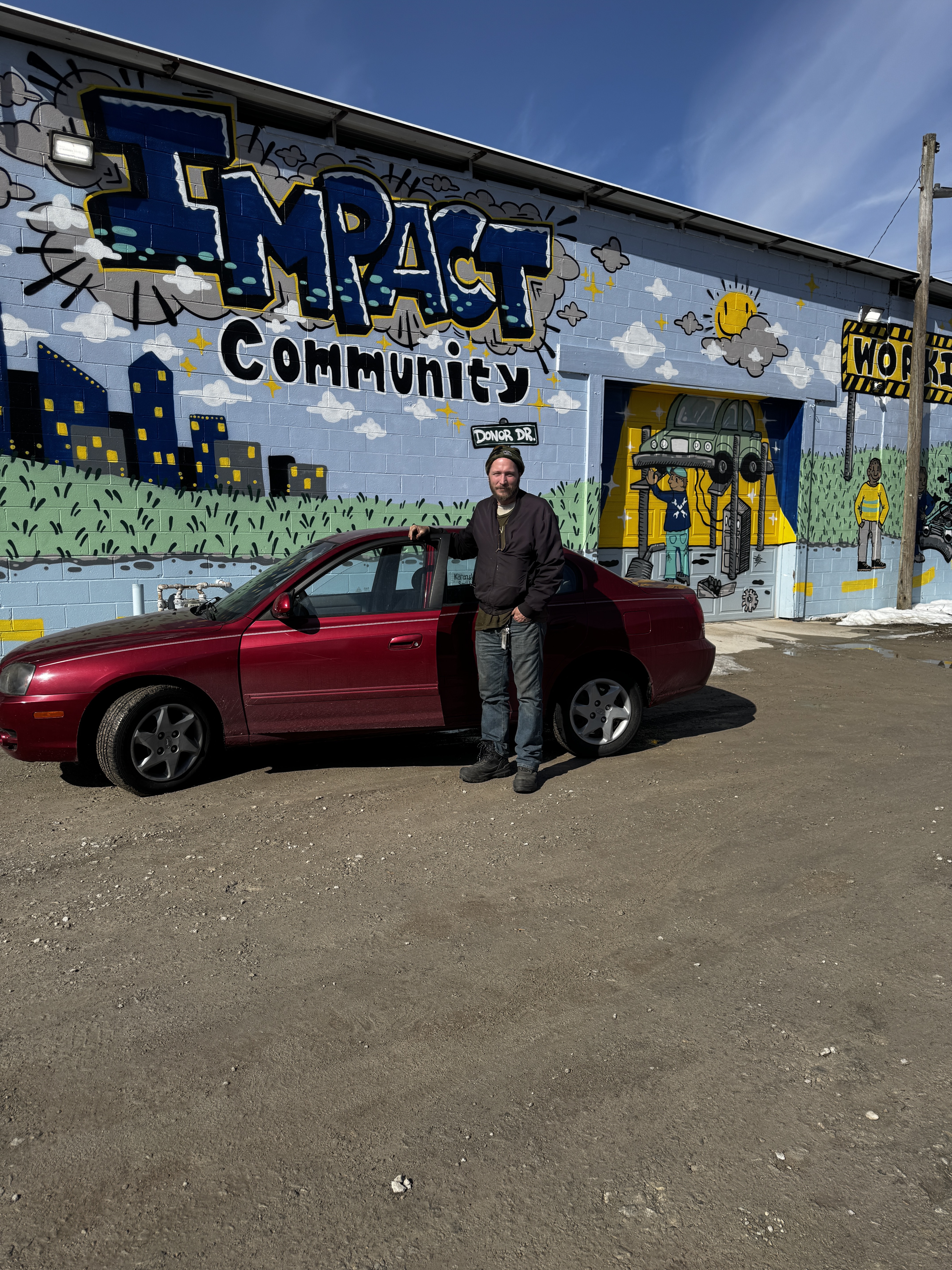 Josh with his vehicle at Impact Garage