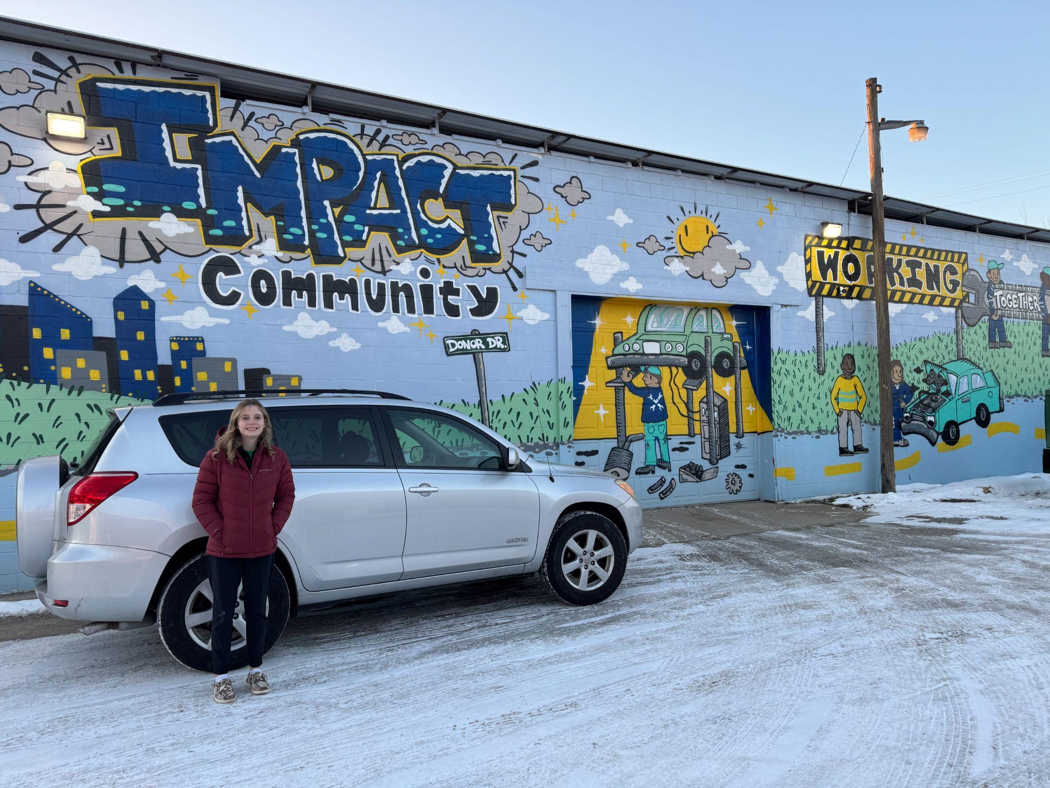 Lani with her vehicle at Impact Garage